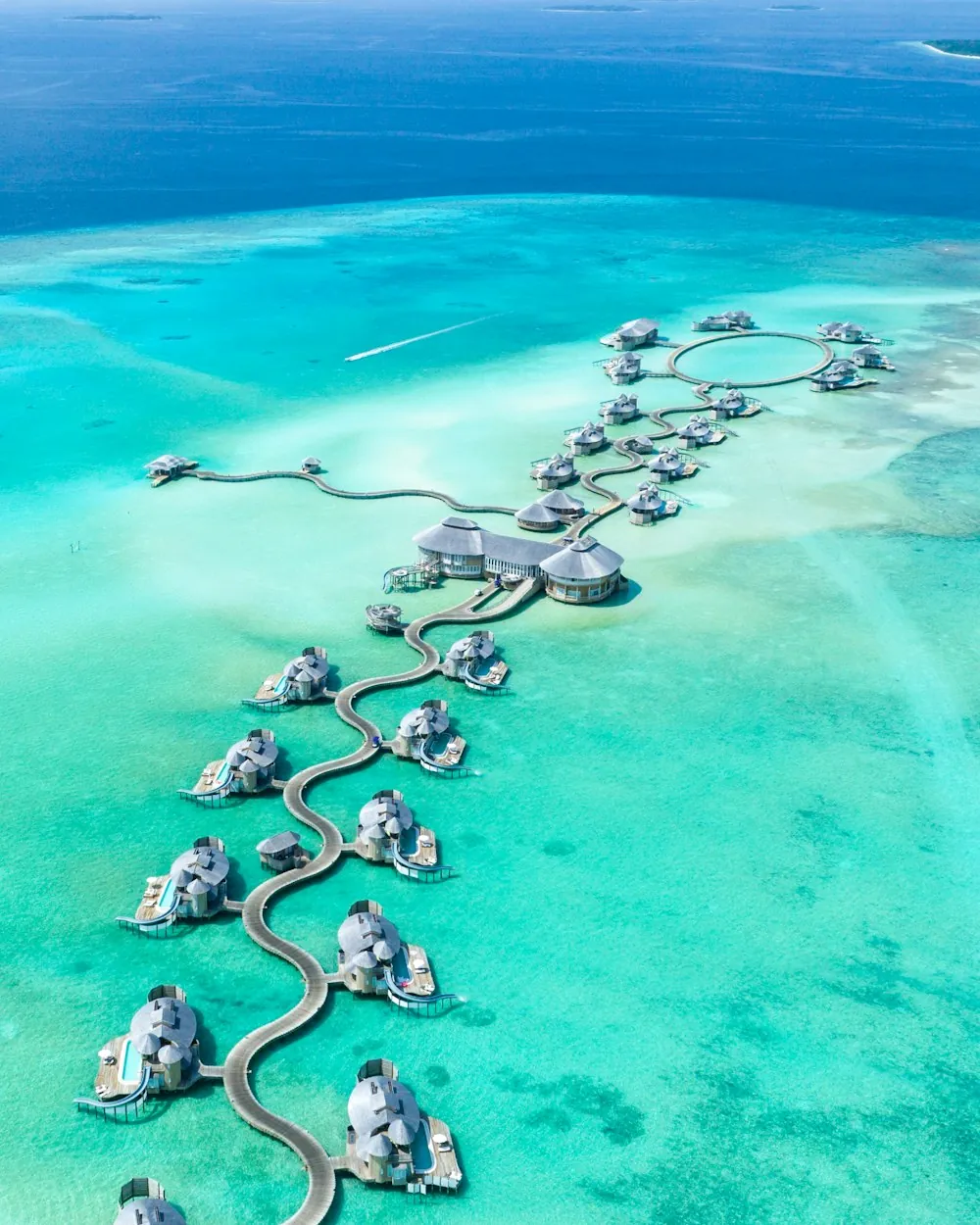 Overwater villas extending into the clear blue waters of the Maldives