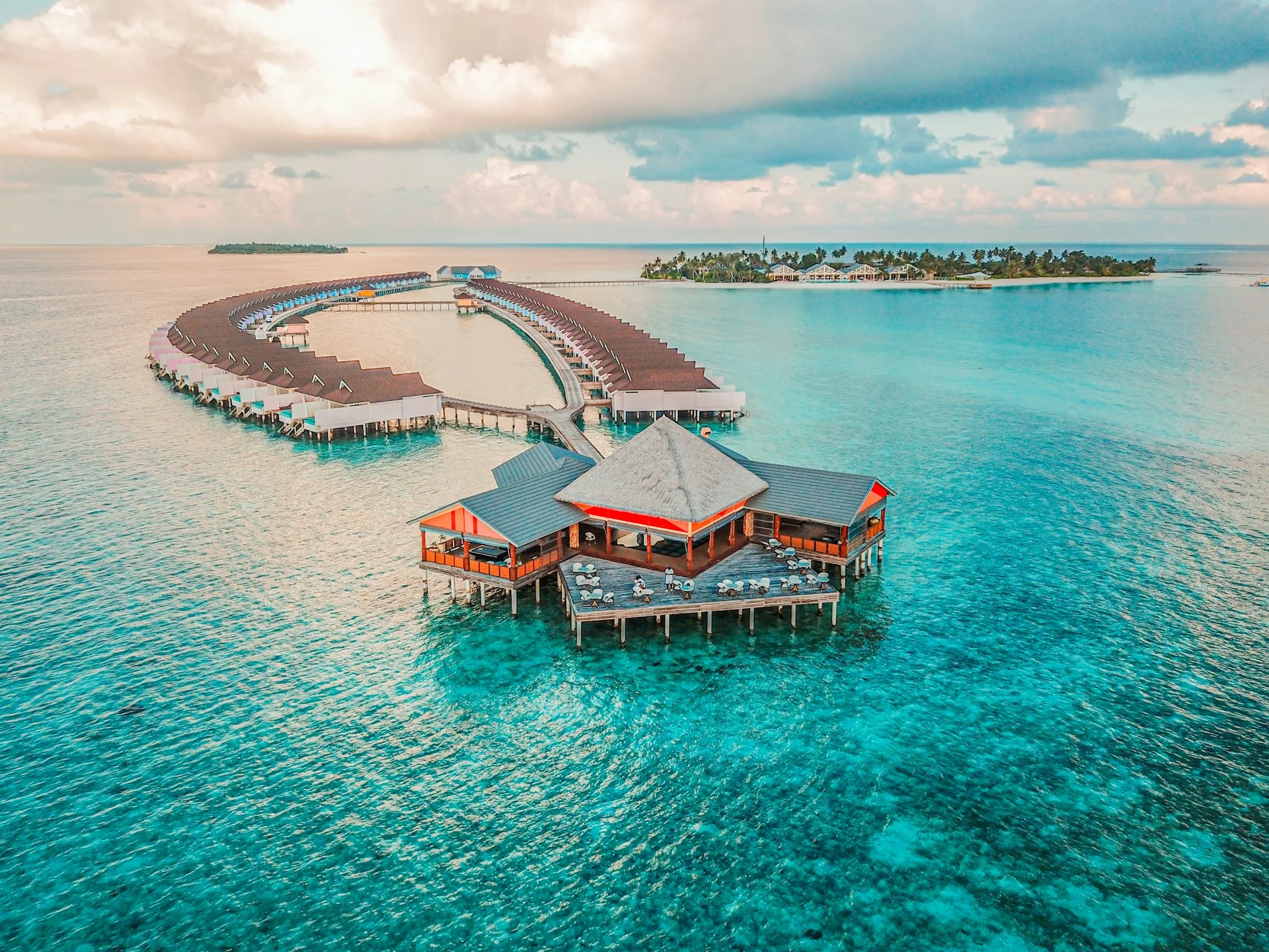 Overwater villas and a tropical island surrounded by turquoise ocean